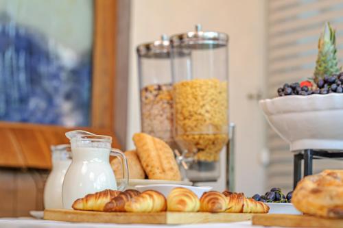 a table with pastries and a blender filled with milk at Ski Hotel in Žabljak