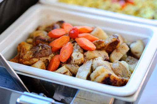 a styrofoam container of food with carrots and meat at Ski Hotel in Žabljak