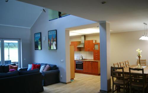 a living room and kitchen with a couch and a table at Siedlisko Błotnia in Mierzeszyn