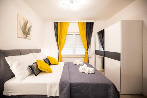 a bedroom with a bed with two stuffed animals on it at Villa Anđelina in Zadar near the city center with private pool and sauna - by TA Leut Agency in Zadar