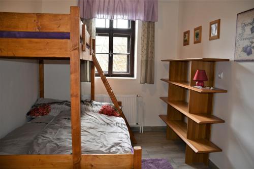 a bedroom with two bunk beds and a window at Na koňské farmě in Malečov