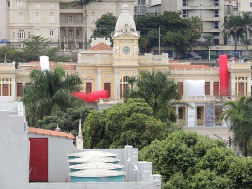a building with a clock tower in front of it at Hotel Esplanada Belo Horizonte - Proximo a Estacao de Trem in Belo Horizonte
