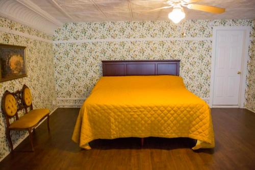 a bedroom with a yellow bed in a room at Object Hotel - 1A Loft in Bisbee