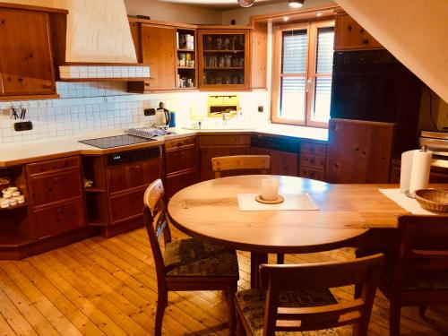 a kitchen with a wooden table and a wooden floor at Gemütliche Fewo Nähe Hachenburg, Bad Marienberg in Langenbach bei Kirburg