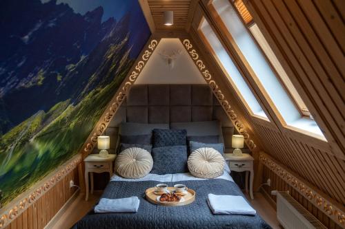 a bedroom with a bed with a tray of food on it at Chałpa u Zbójnika in Zakopane