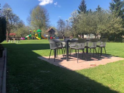 a table and chairs in a park with a playground at Casa Codrin in Bran