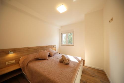 Postel nebo postele na pokoji v ubytování Apartmani Kiara