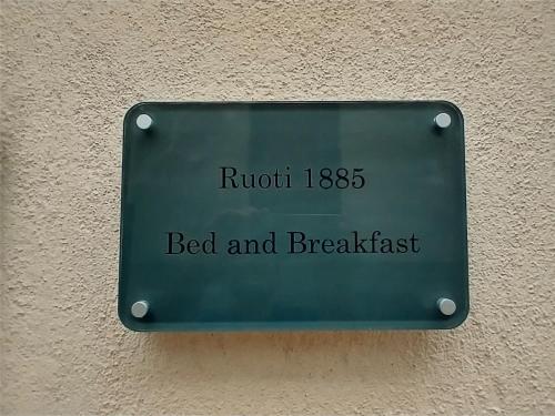 a sign for a bed and breakfast on a wall at Ruoti 1885 in Ruoti