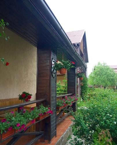 a house with flower boxes on the side of it at Котедж-парк Славна in Okhtyrka