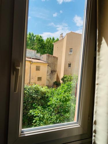an open window with a view of a city at Chambre Le Merindol in Aix-en-Provence