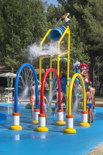 a group of children playing in a water park at Glamping and Mobile Homes Lavanda - Holiday Centre Bi VIllage in Fažana