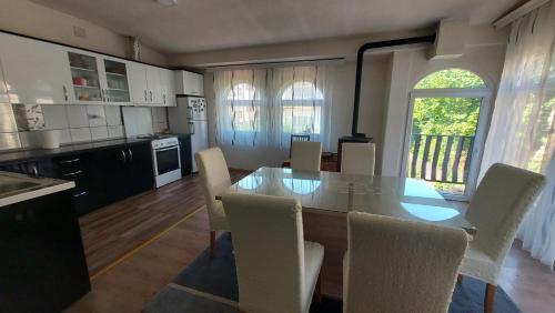 a kitchen and dining room with a table and chairs at Petroski Apartments in Ohrid