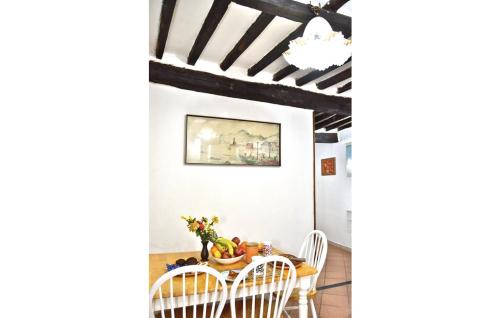 a dining room with a table and chairs and a chandelier at La casetta del Marinaio in Tellaro