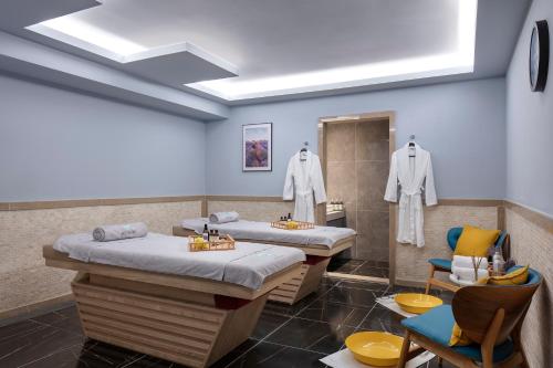 a hospital room with two beds and a chair at Nirvana Cosmopolitan in Lara