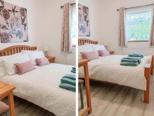 a bedroom with two beds and a table at The Bungalow in York