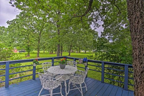 a patio with a table and chairs on a deck at Hot Tub and Deck Tranquil Home Near Grand Lake in Grove