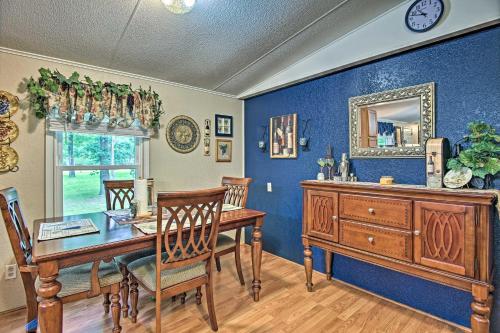 a dining room with a table and a mirror at Hot Tub and Deck Tranquil Home Near Grand Lake in Grove