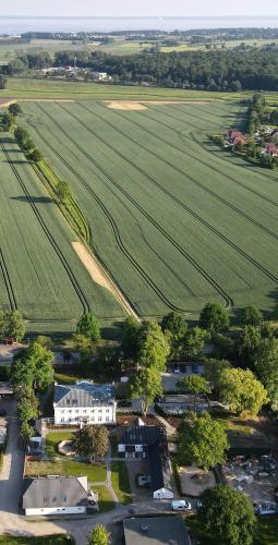 an aerial view of a small village with a farm at Gasthaus am Henriettenhof in Grömitz