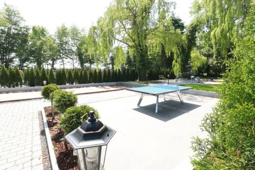 a ping pong table in a courtyard with trees at Gasthaus am Henriettenhof in Grömitz