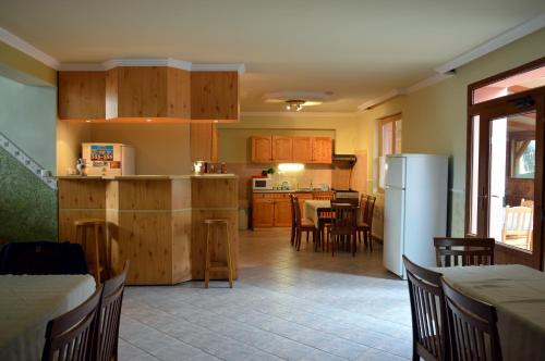 a kitchen and dining room with a table and a refrigerator at Flamingo Vendégház in Eger