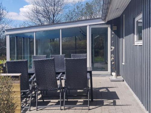 a group of chairs sitting on a patio at 8 person holiday home in Fars in Ertebølle