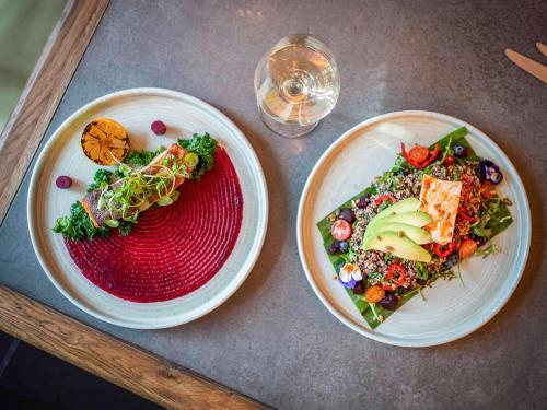 a table with two plates of food and a glass at Castle Hotel Windsor in Windsor