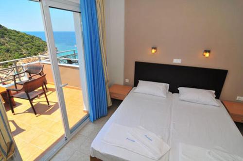 a bedroom with a bed and a balcony at Thalassorama Studios in Skala Marion