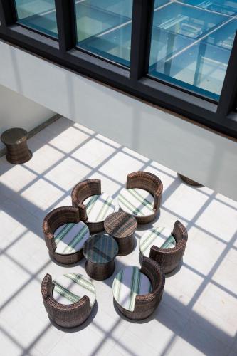 a group of chairs sitting on a tiled floor at Lovestar Lakeside Hotel - Starlight Building in Hengchun