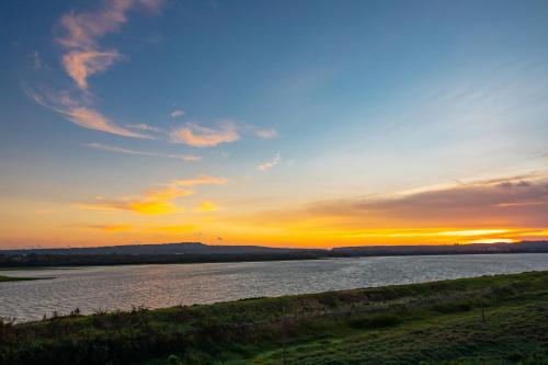 a sunset over a body of water with the sky at Lovestar Lakeside Hotel - Starlight Building in Hengchun