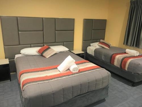 Ένα ή περισσότερα κρεβάτια σε δωμάτιο στο Toukley Motor Inn