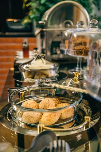 a group of trays of muffins on a counter at Alfonsina Hotel Boutique in Santa Cruz de la Sierra