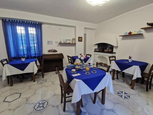 a dining room with two tables and a stove at Astra in Agerola