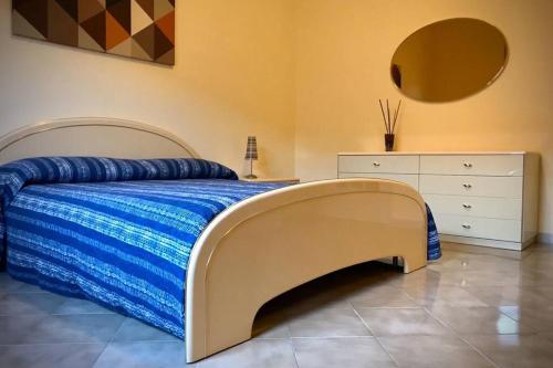 a bedroom with a large bed and a dresser at Fuoco dell’Etna in Nicolosi