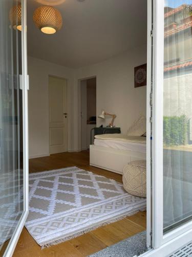 a room with a bed and a glass door at Seeschilf Apartments in Friedrichshafen in Friedrichshafen