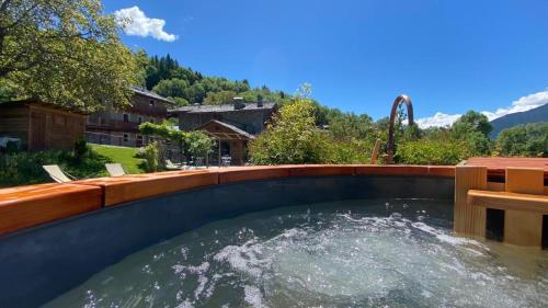 a large swimming pool with water in a backyard at Maison Perriere - Chambres d'hôtes & Jacuzzi in Saint Vincent