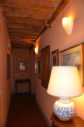 a lamp sitting on a table in a hallway at Agriturismo Al Podere Di Rosa in Sant' Alessio