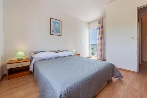 a bedroom with a bed and a window at Olive gardens in Primošten