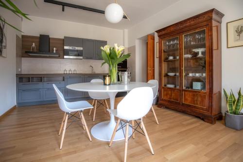 a kitchen with a white table and chairs at Dimora Manieri in LʼAquila