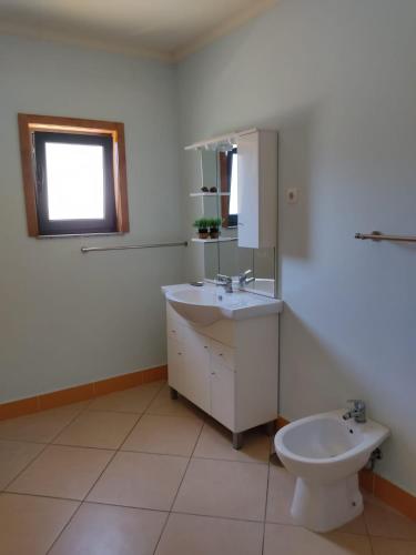 a bathroom with a sink and a toilet at Casa do Vale - Casa da Montanha - Gerês in Geres