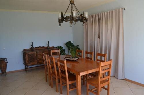 a dining room with a wooden table and chairs at Casa do Vale - Casa da Montanha - Gerês in Geres