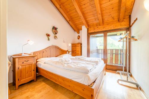 a bedroom with a bed and a window at Dolomites Dream Arabba in Masarei