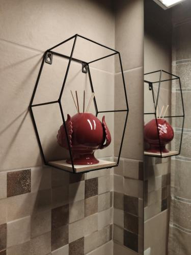 two glass shelves with a red vase on them at Tizzy Apartment & Rooms in Bari