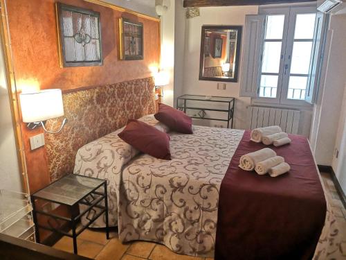 a bedroom with a bed with two towels on it at Il Torrione in Castiglione del Lago