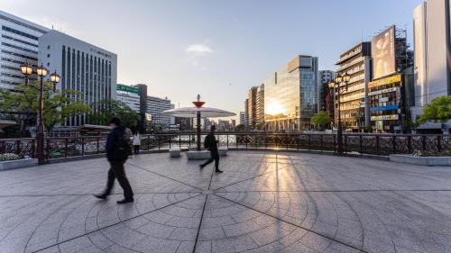 two people walking down a street in a city at THE LIVELY FUKUOKA HAKATA in Fukuoka
