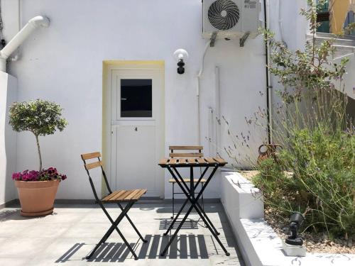 two chairs and a table on a patio at Katsikantaris Homes in Paphos City