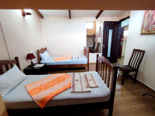 una habitación con dos camas y una mesa y sillas en G&L APARTMENTS, en Tiflis