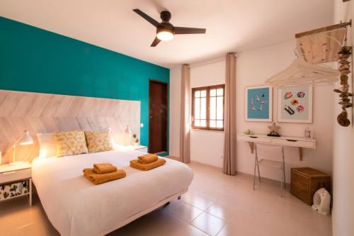 a bedroom with a bed with two towels on it at Quinta do Paraíso - Bed&Shower in Albufeira