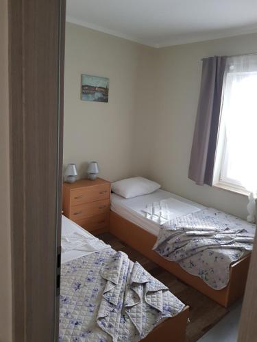 Postel nebo postele na pokoji v ubytování Apartman M.I.R.A.