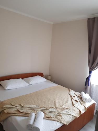a bedroom with a bed with white towels on it at Apartman M.I.R.A. in Cres