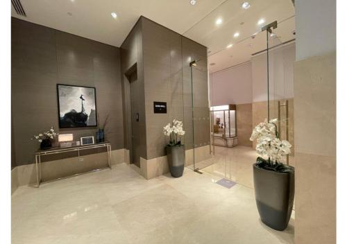 a lobby with two large vases with flowers in it at Dubai Mall Residences -Luxury 1 bedroom in Dubai